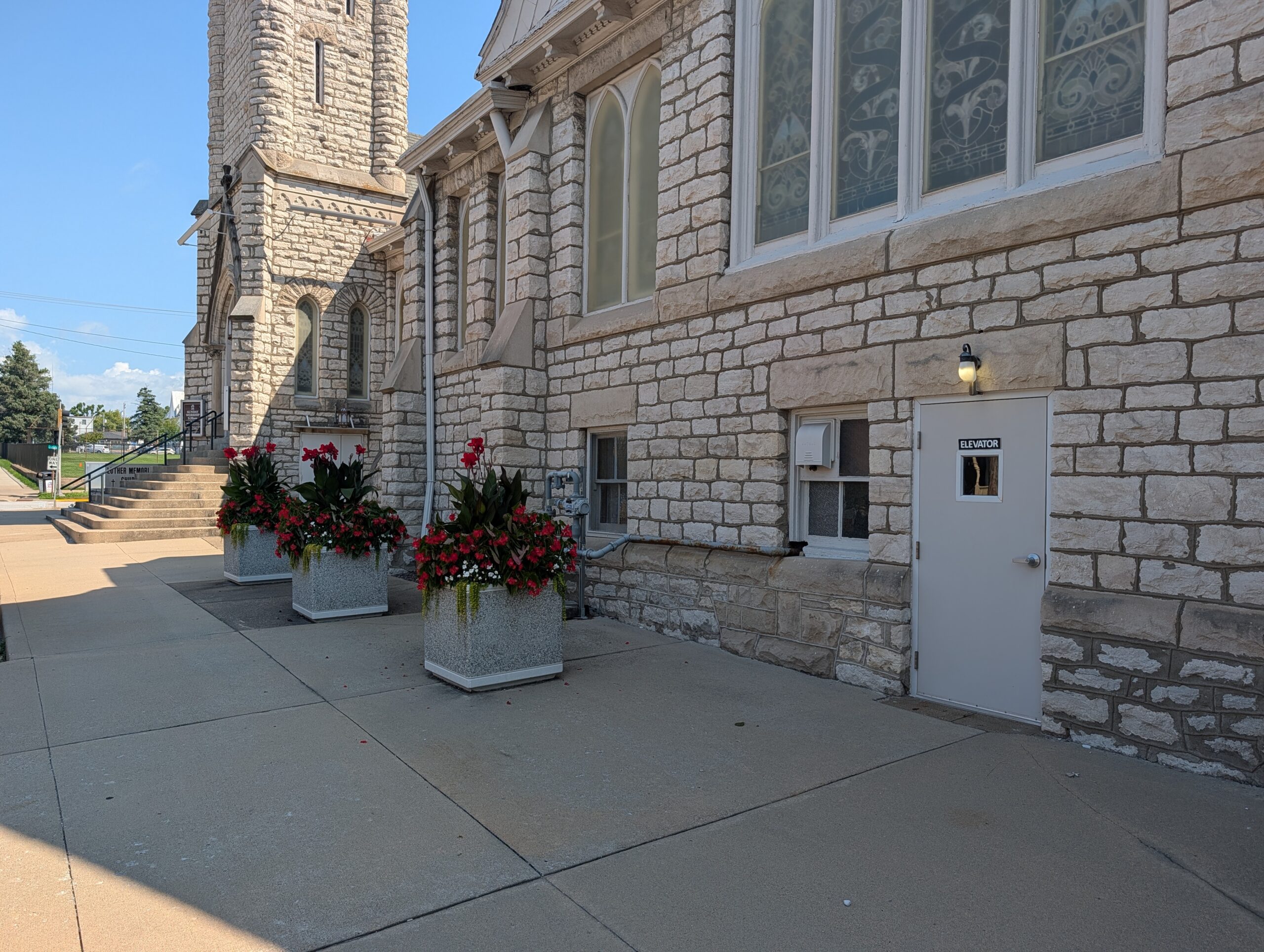 Street-level elevator entrance beside the sanctuary stairs